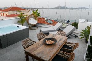 a patio with a table and a bath tub at The Well View in Preveza