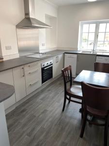 a kitchen with a table and a stove top oven at The Peel Aldergate in Tamworth