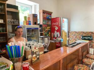 a woman sitting at a counter in a coffee shop at Country House & Restaurant Hronec in Hronec