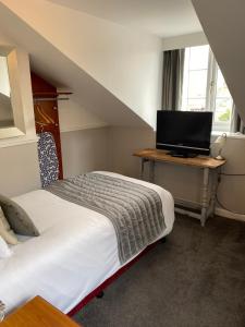 A bed or beds in a room at The Peel Aldergate 