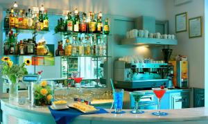 a bar with drinks on a counter in a kitchen at Aurea Hotel in Tortoreto Lido