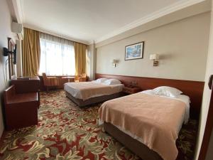 a hotel room with two beds and a window at Hotel Monopol in Istanbul