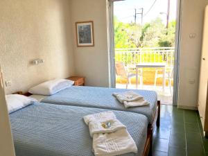 A bed or beds in a room at Galini Studios and Apartments