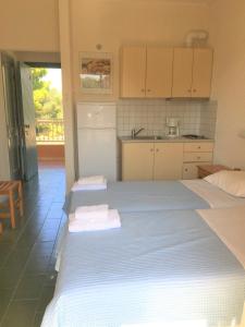 A bed or beds in a room at Galini Studios and Apartments