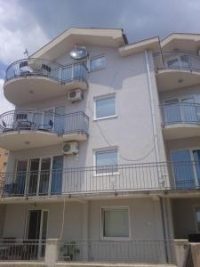 a large white building with balconies on it at Luxury Villas Marko in Tivat