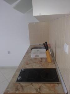 a kitchen counter with a stove and a knife at Luxury Villas Marko in Tivat