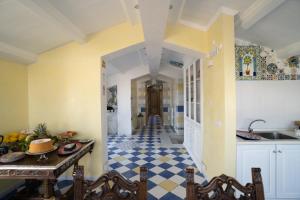 a kitchen with a checkered floor and a hallway at CASSIODORO SUITE B&B in Marina di Davoli
