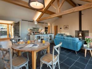 a living room with a table and a blue couch at Kirkstone in Kendal