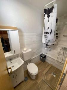 a bathroom with a toilet and a sink at TARA BUNGALOV in Žabljak +13 photos