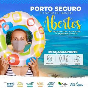 un póster para un complejo de playa con una mujer con una máscara sosteniendo un inflable en Casa Porto Mar América Praia, en Porto Seguro