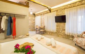 a living room with a couch and a tv at Stone Suites at Lefkada's Old Port in Lefkada