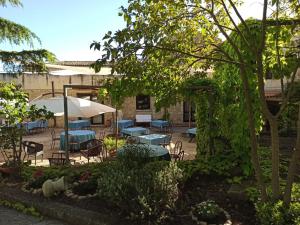 a patio with tables and chairs in a yard at Villa Padura in Castellana Sicula