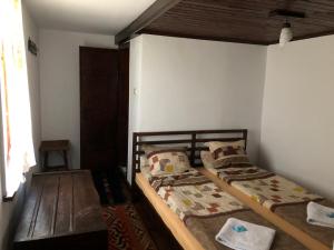 a bedroom with two beds in a room at Etnographic Houses in Dŭlbok Dol