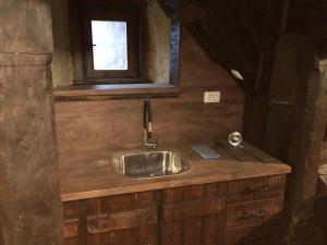 a kitchen sink in a cabin with a window at Etnographic Houses in Dŭlbok Dol +84 photos