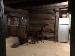 a room with two chairs and a refrigerator at Etnographic Houses in Dŭlbok Dol