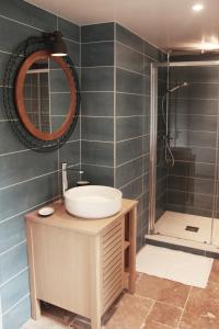 a bathroom with a sink and a shower at Kapera Maison d'Hotes in Macaye