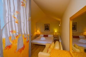 a room with two beds and a mirror at Persephone Cottage by AgroHolidays in Platres