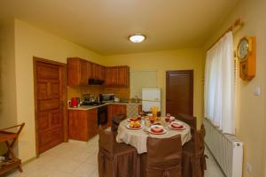 a kitchen with a table and chairs in a room at Persephone Cottage by AgroHolidays in Platres