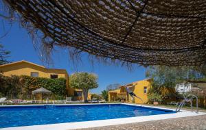 a swimming pool in front of a house at Cortijo Amaya in Torrox Costa