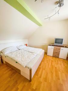 ein Schlafzimmer mit einem Bett und einem TV in der Unterkunft Vural Rooms in Gmünd