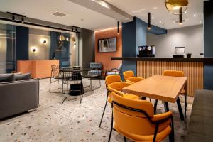 a restaurant with tables and chairs and a bar at Bob W Athens Akadimia in Athens
