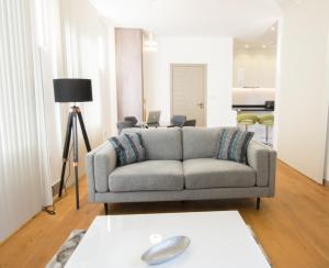 a living room with a couch and a table at Kew Bridge by Charles Hope in London