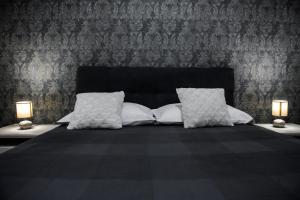 a bedroom with a bed with two lamps on tables at Family dream house in Ružić +39 photos