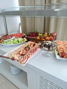 a buffet with many different types of food on a table at Hotel Tourist - Metropol Lake Resort in Ohrid
