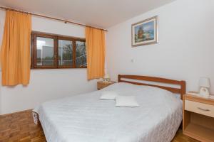 a bedroom with a bed and a window at Guest House Vulić in Dubrovnik