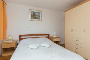 a bedroom with a bed with two pillows on it at Guest House Vulić in Dubrovnik