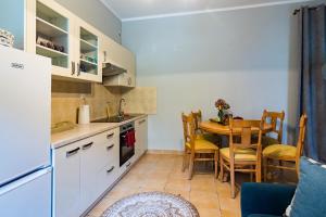 a kitchen and dining room with a table and chairs at Pokoje gościnne przy Rynku in Dąbrówno +10 photos
