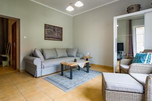 a living room with a couch and a table at Pokoje gościnne przy Rynku in Dąbrówno