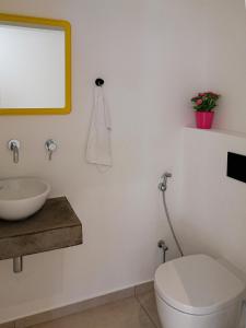 a bathroom with a sink and a toilet and a mirror at Villa Aetos in Paleros +34 photos
