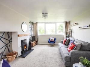 a living room with a couch and a fireplace at Arlan in Benllech