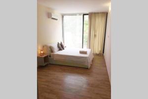 a bedroom with a bed and a large window at Mellieha Luxury Penthouse with sea & country views in Mellieħa