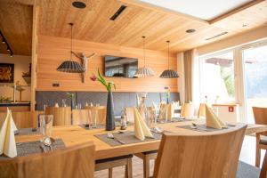 a dining room with a long table and chairs at Geisler-Moroder in Elbigenalp