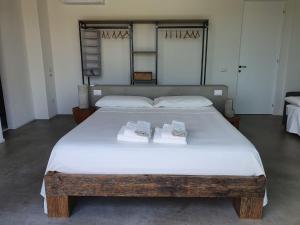 a bedroom with a large bed with two towels on it at Casa Lunaria B&B in Porto SantʼElpidio +37 photos