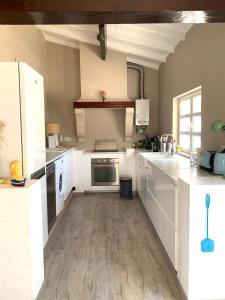 a kitchen with white cabinets and a counter top at Casa Paloma in Comporta