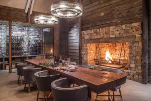 Kariega Game Reserve Settlers Drift في أليكساندريا: غرفة طعام مع طاولة طويلة ومدفأة