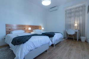 Postel nebo postele na pokoji v ubytování Lagoa Hostel & Suites