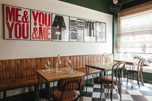 a restaurant with tables and chairs and a picture on the wall at The fig in Rye