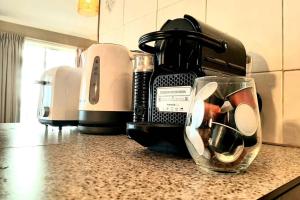a kitchen counter with a coffee maker and a mixer at Sunset Balcony Bass Coast Beach House in Grantville