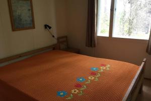 a bedroom with a bed with flowers on it at Cotteg Marjakallio (BerryRock) in Punkaharju