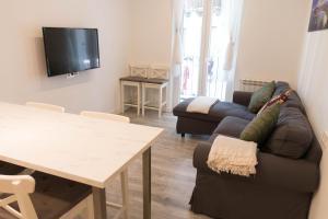 a living room with a couch and a table at Modern Apartment in Central Romantic Quarter in San Sebastián