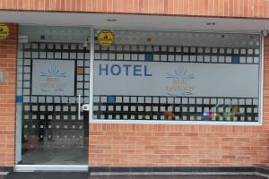 a hotel sign in the window of a brick building at Hotel Real Estación in Bogotá