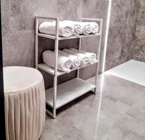 a towel rack with towels on it in a bathroom at Apartament w Centrum in Zamość +9 photos