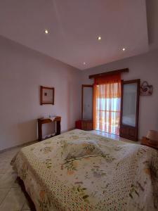 a bedroom with a large bed and a window at George's Apartment in Loutraki