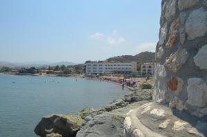 a group of people on a beach near the water at Tylos Beach Hotel in Kato Pyrgos