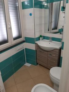 a bathroom with a toilet and a sink at casa anna in Vico Equense