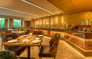 a dining room with a table and chairs at Sapphire Boutique Hotel in Navi Mumbai
